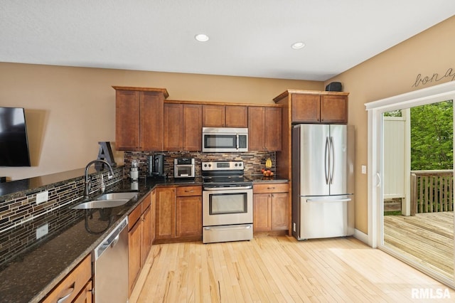 725 Cox Ct, Le Claire, IA 52753 - kitchen with stainless steel appliances, a sink, brown cabinets, backsplash, and recessed lighting