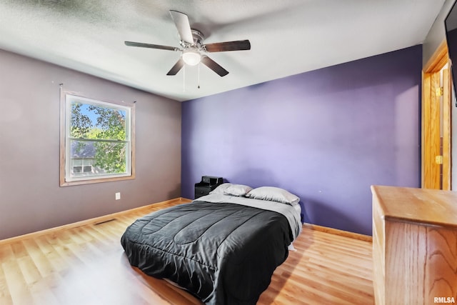 5812 N Thornwood Ave, Davenport, IA 52806 - bedroom featuring wood finished floors, baseboards, and a ceiling fan