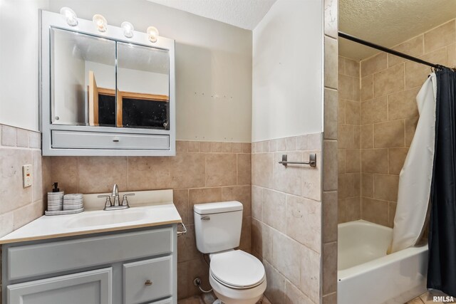 5812 N Thornwood Ave, Davenport, IA 52806 - bathroom with tile walls, vanity, toilet, shower / tub combo, and a textured ceiling