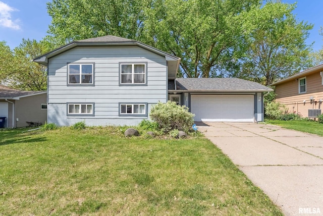 5812 N Thornwood Ave, Davenport, IA 52806 - tri-level home with a garage, driveway, a front lawn, and central AC