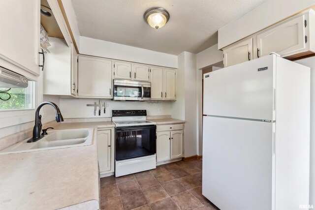 5812 N Thornwood Ave, Davenport, IA 52806 - kitchen with freestanding refrigerator, electric stove, stainless steel microwave, a sink, and light countertops