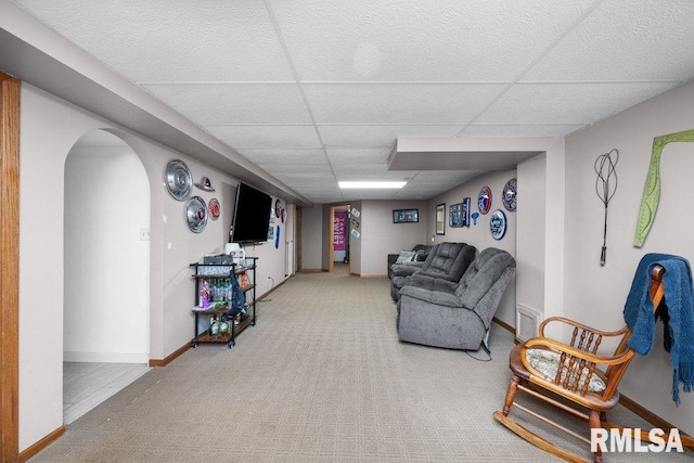 3430 W Locust St, Davenport, IA 52804 - living room with a paneled ceiling, arched walkways, carpet flooring, and baseboards