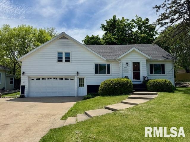 1003 16th Ave N, Clinton, IA 52732 - view of front of house featuring driveway, an attached garage, a front lawn, and roof with shingles