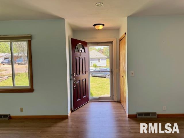 1003 16th Ave N, Clinton, IA 52732 - entrance foyer with wood finished floors, baseboards, and plenty of natural light