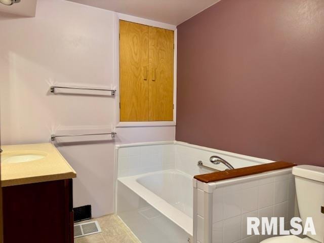 1003 16th Ave N, Clinton, IA 52732 - bathroom featuring a bath, toilet, and vanity