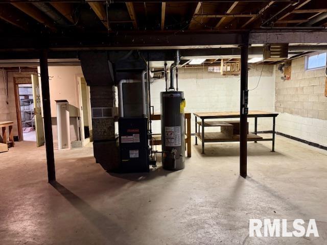 1003 16th Ave N, Clinton, IA 52732 - basement with water heater, heating unit, and concrete block wall