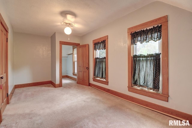 1845 S Bluff Blvd, Clinton, IA 52732 - empty room featuring light colored carpet, plenty of natural light, baseboards, and ceiling fan