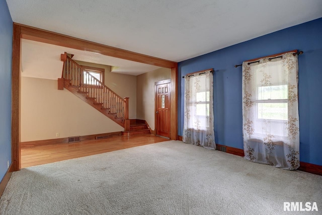 1845 S Bluff Blvd, Clinton, IA 52732 - carpeted foyer featuring stairs, healthy amount of natural light, and baseboards
