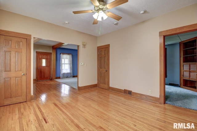 1845 S Bluff Blvd, Clinton, IA 52732 - spare room featuring baseboards, light wood-style flooring, and ceiling fan