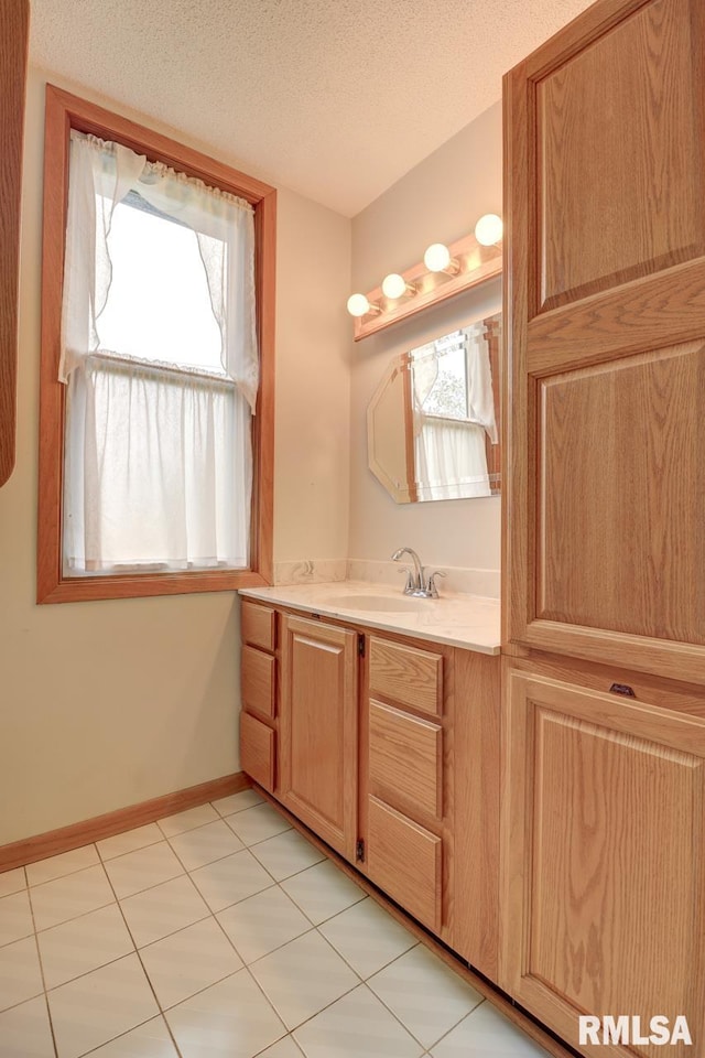 1845 S Bluff Blvd, Clinton, IA 52732 - bathroom featuring vanity, a textured ceiling, baseboards, and tile patterned flooring