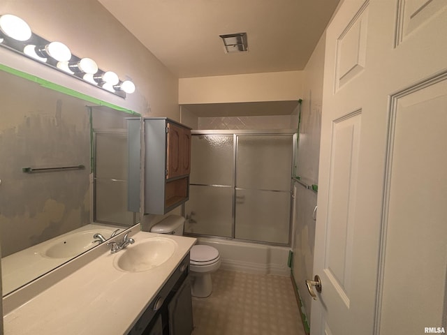 920 17th St Unit 28, Moline, IL 61265 - full bathroom featuring toilet, vanity, and bath / shower combo with glass door