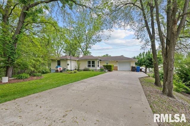 ranch-style home featuring concrete driveway, a garage, a front yard, and a chimney