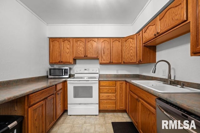 kitchen featuring stainless steel appliances, a sink, brown cabinetry, dark countertops, and ornamental molding