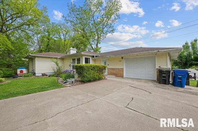 single story home with concrete driveway, a front lawn, an attached garage, brick siding, and a chimney