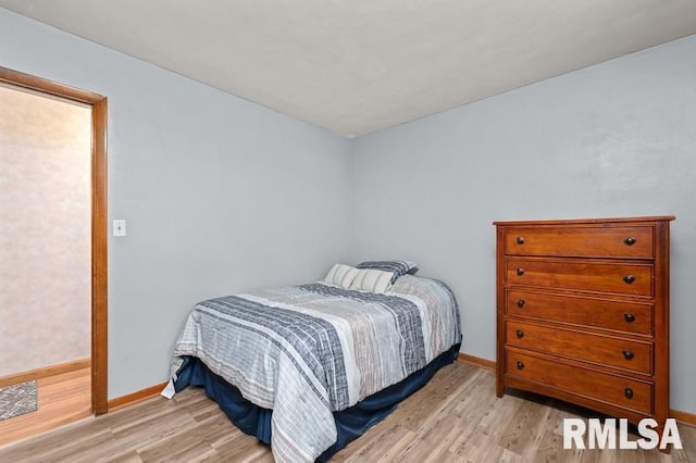 bedroom featuring light wood-type flooring and baseboards