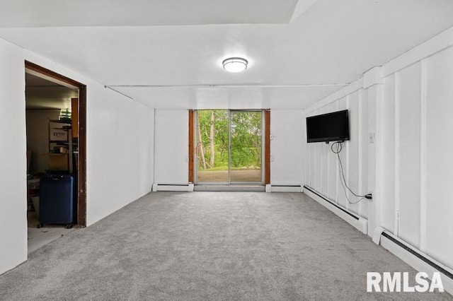 basement with a baseboard heating unit, a baseboard radiator, and carpet flooring