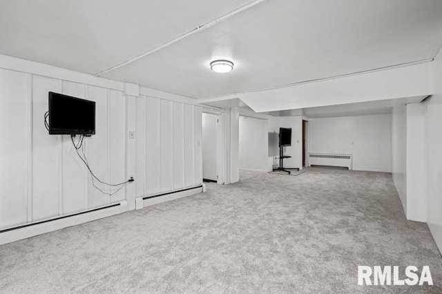 finished below grade area with carpet flooring, radiator, and baseboard heating