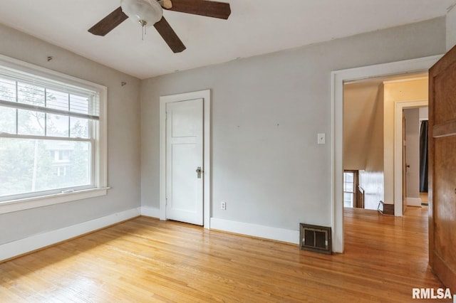 2505 Iowa St, Davenport, IA 52803 - spare room featuring ceiling fan, light wood finished floors, and baseboards