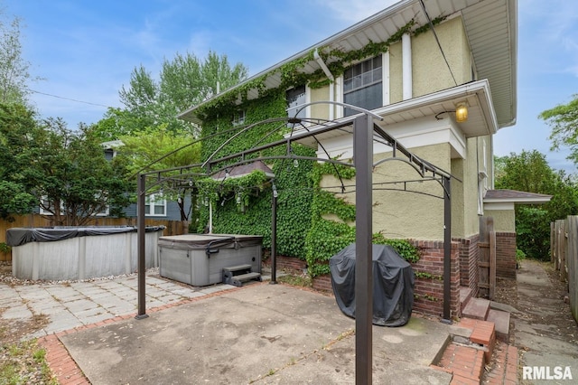 2505 Iowa St, Davenport, IA 52803 - view of patio / terrace with a hot tub, a fenced backyard, a grill, and a covered pool