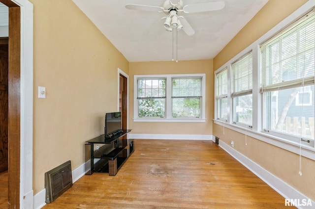 2505 Iowa St, Davenport, IA 52803 - unfurnished sunroom with baseboards and wood finished floors