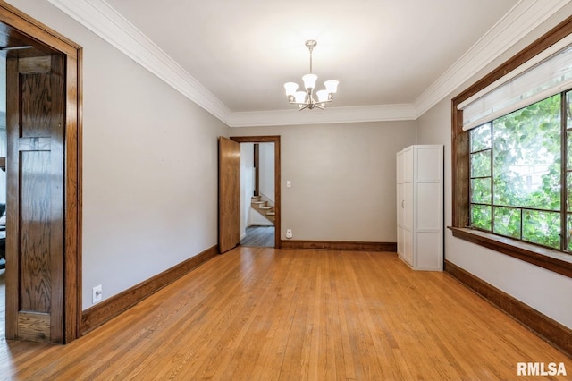 2505 Iowa St, Davenport, IA 52803 - spare room with light wood-type flooring, crown molding, a chandelier, stairs, and baseboards
