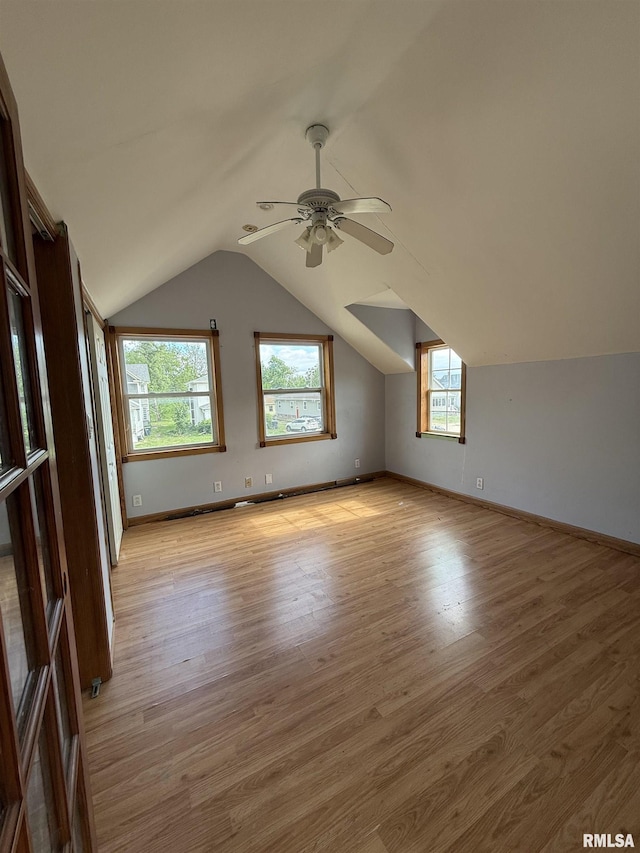 237 1st Ave, Clinton, IA 52732 - additional living space with light wood-type flooring, ceiling fan, vaulted ceiling, and baseboards
