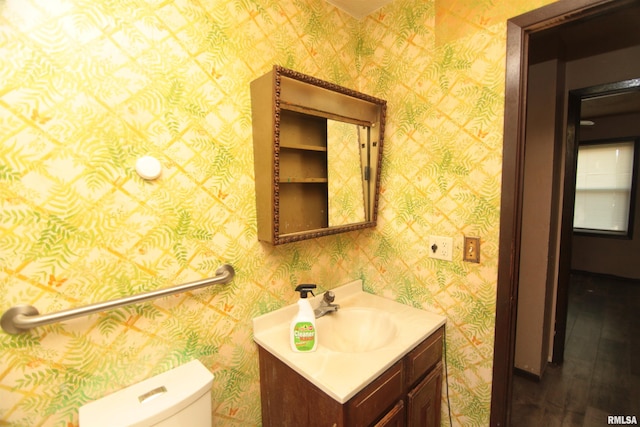 2630 N Concord St, Davenport, IA 52804 - half bath featuring toilet, vanity, and wood finished floors