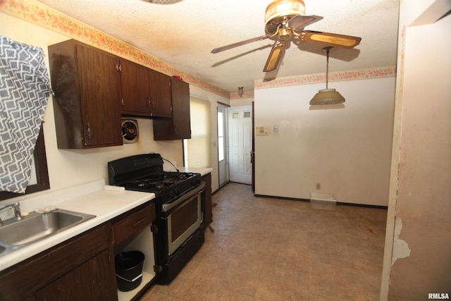 2630 N Concord St, Davenport, IA 52804 - kitchen with gas range, ceiling fan, light countertops, a sink, and dark brown cabinetry