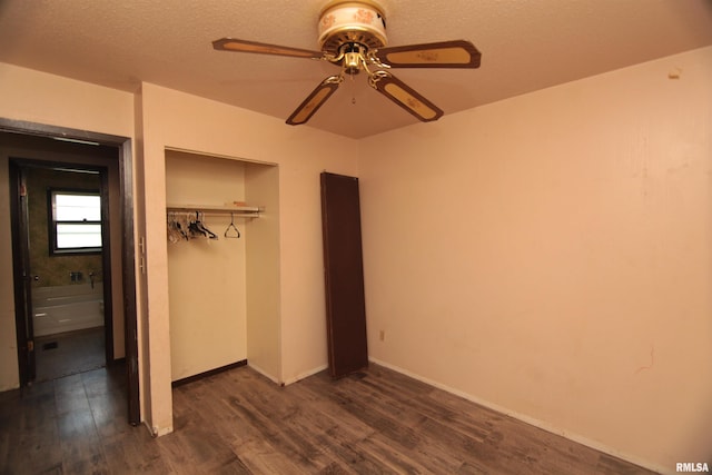 2630 N Concord St, Davenport, IA 52804 - unfurnished bedroom featuring dark wood finished floors, a closet, ceiling fan, baseboards, and a textured ceiling