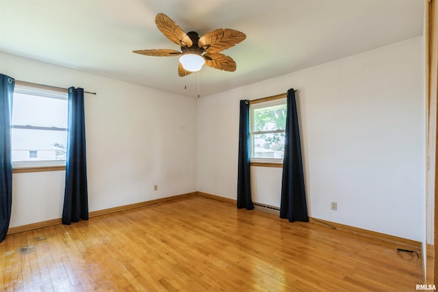 empty room with light wood-type flooring, ceiling fan, and baseboards