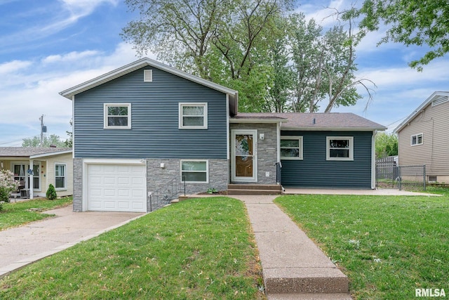 2845 Washington Ln, Davenport, IA 52804 - tri-level home with stone siding, an attached garage, and driveway