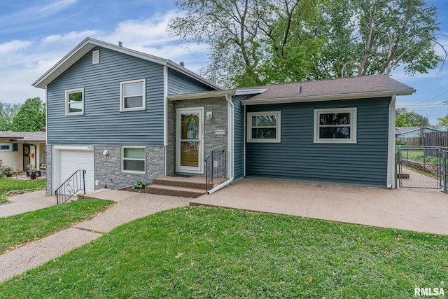 2845 Washington Ln, Davenport, IA 52804 - view of front facade with stone siding, an attached garage, and driveway