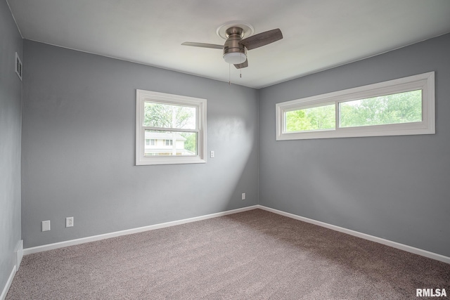 2845 Washington Ln, Davenport, IA 52804 - spare room featuring ceiling fan, carpet, and baseboards