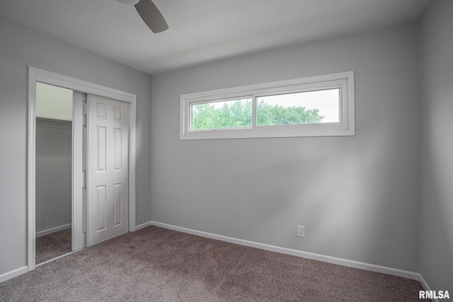 2845 Washington Ln, Davenport, IA 52804 - unfurnished bedroom featuring carpet flooring, baseboards, a closet, and a ceiling fan