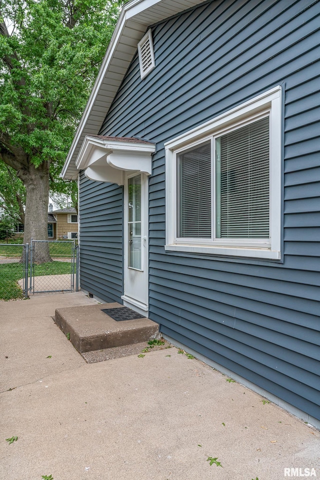 2845 Washington Ln, Davenport, IA 52804 - view of exterior entry with a gate and a patio