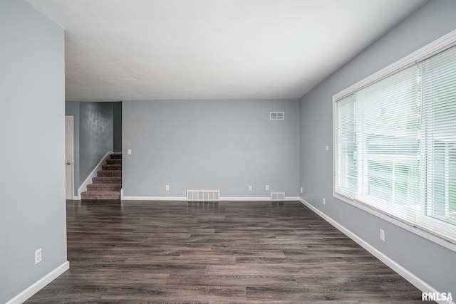 2845 Washington Ln, Davenport, IA 52804 - unfurnished room featuring stairway, dark wood-type flooring, and baseboards