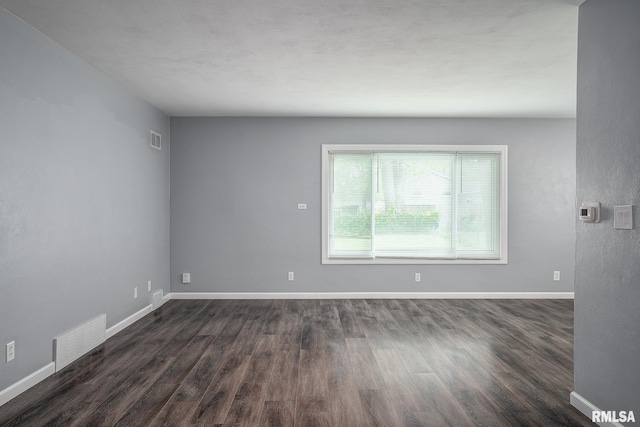 2845 Washington Ln, Davenport, IA 52804 - empty room featuring dark wood-style floors and baseboards
