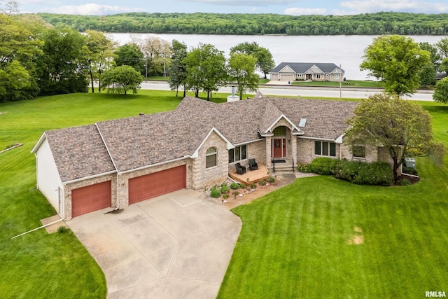 23835 284th Ave, Le Claire, IA 52748 - ranch-style house featuring a garage, driveway, a water view, a front yard, and brick siding