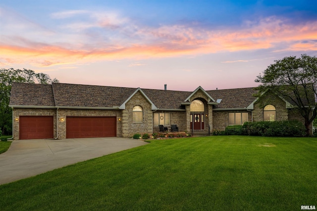 23835 284th Ave, Le Claire, IA 52748 - view of front of property with a yard, an attached garage, concrete driveway, brick siding, and a shingled roof
