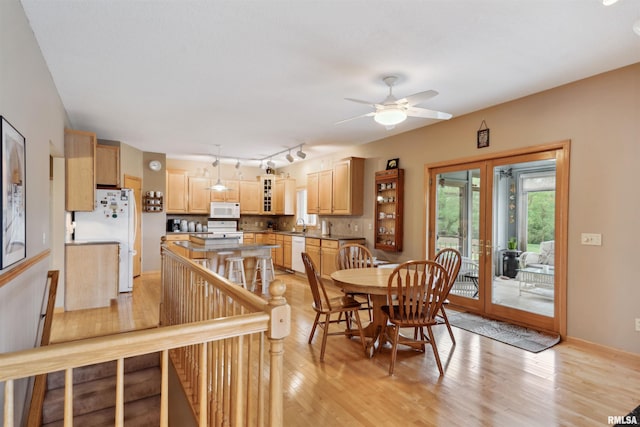 23835 284th Ave, Le Claire, IA 52748 - dining area with french doors, light wood-style flooring, and a ceiling fan