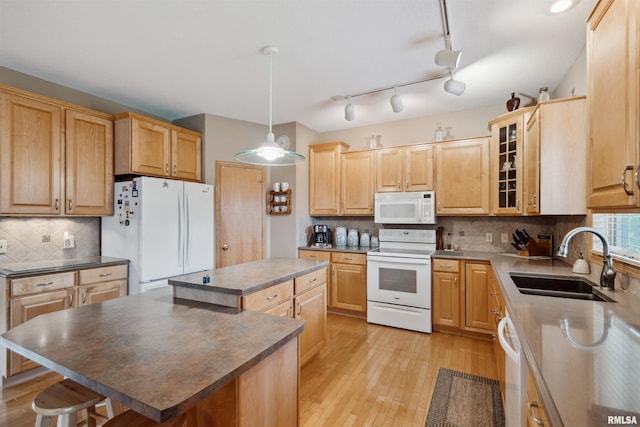 23835 284th Ave, Le Claire, IA 52748 - kitchen featuring white appliances, a sink, a kitchen island, and light wood-style flooring