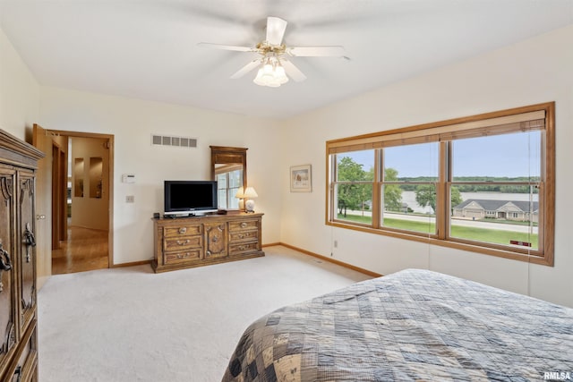 23835 284th Ave, Le Claire, IA 52748 - bedroom featuring baseboards, light colored carpet, and ceiling fan