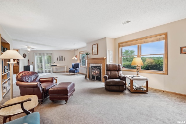 23835 284th Ave, Le Claire, IA 52748 - living room with carpet, a high end fireplace, baseboards, a ceiling fan, and a textured ceiling
