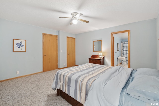 23835 284th Ave, Le Claire, IA 52748 - carpeted bedroom with ensuite bath, baseboards, and a ceiling fan