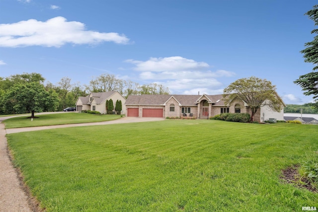 23835 284th Ave, Le Claire, IA 52748 - view of front of home featuring a garage, concrete driveway, and a front yard