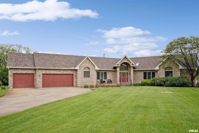 23835 284th Ave, Le Claire, IA 52748 - view of front of home with a garage, a front lawn, concrete driveway, and a shingled roof
