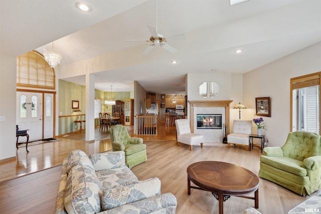 23835 284th Ave, Le Claire, IA 52748 - living room with light wood finished floors, ceiling fan, recessed lighting, a chandelier, and a tile fireplace