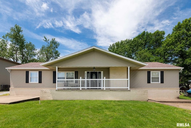 324 N Broadway, Goreville, IL 62939 - ranch-style home with a front yard, brick siding, a porch, and central air condition unit