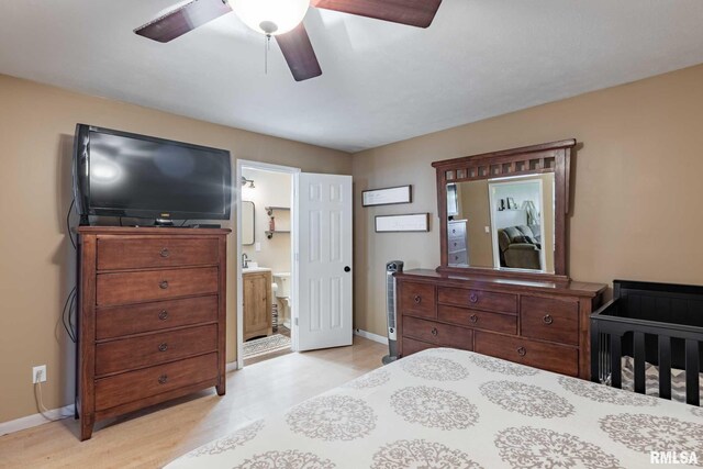 324 N Broadway, Goreville, IL 62939 - bedroom featuring baseboards, light wood-style flooring, ensuite bathroom, and ceiling fan