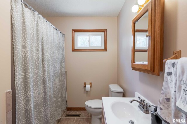 324 N Broadway, Goreville, IL 62939 - bathroom featuring plenty of natural light, toilet, tile patterned floors, and baseboards